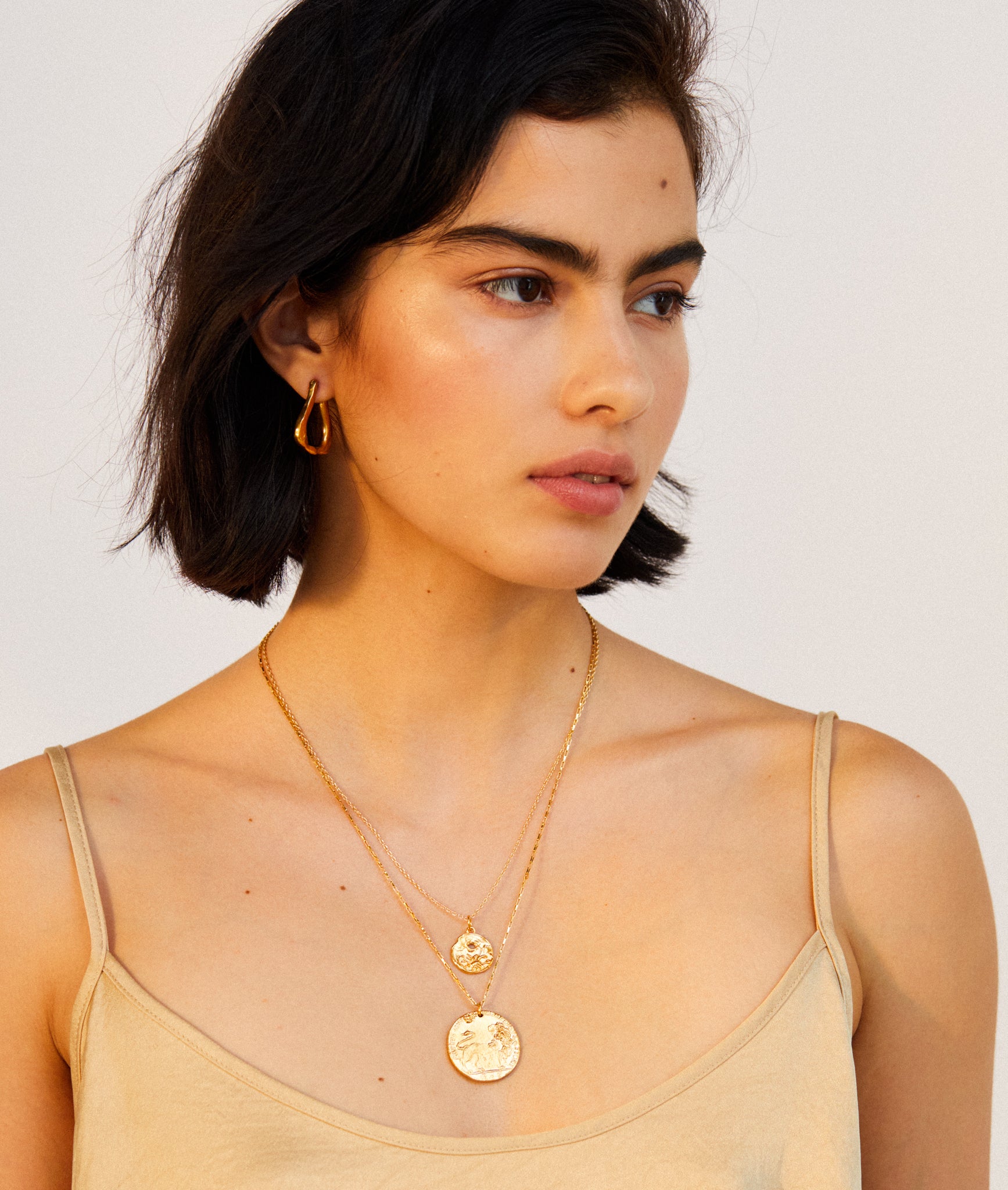 model wearing Alighieri Gold Plated Scorpio Zodiac Necklace Medallion layering necklaces
