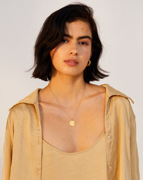 model wearing Alighieri signature gold leone medallion medium coin necklace