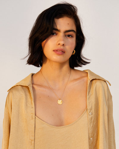 model wearing Alighieri signature gold leone medallion medium coin necklace