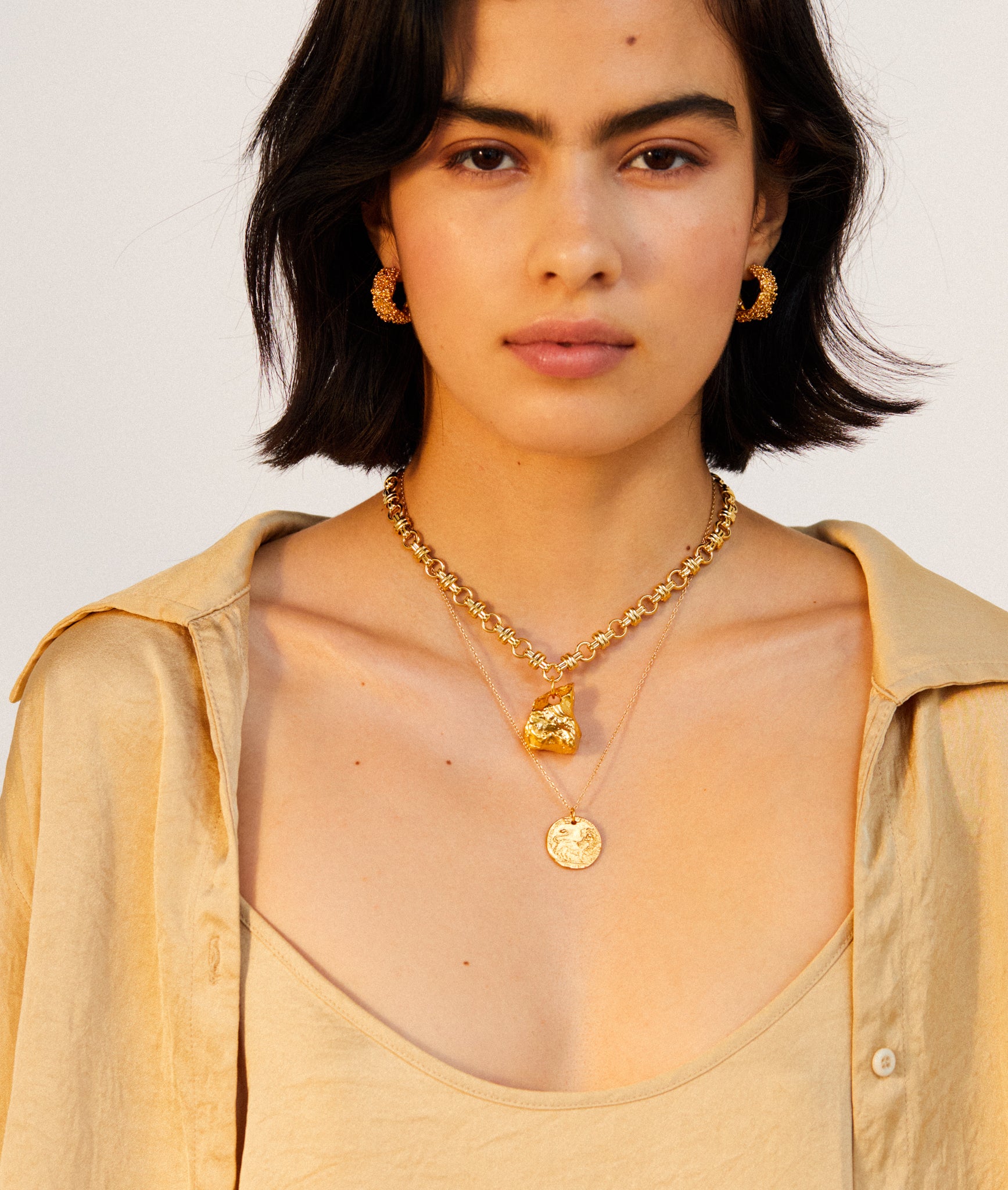model wearing Alighieri signature gold leone medallion medium coin necklace