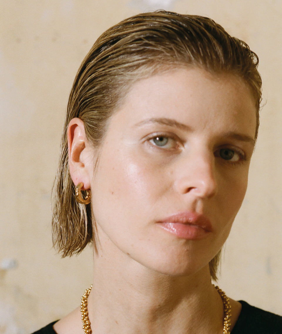 Model wearing Alighieri Gold Earrings Cats Cradle
