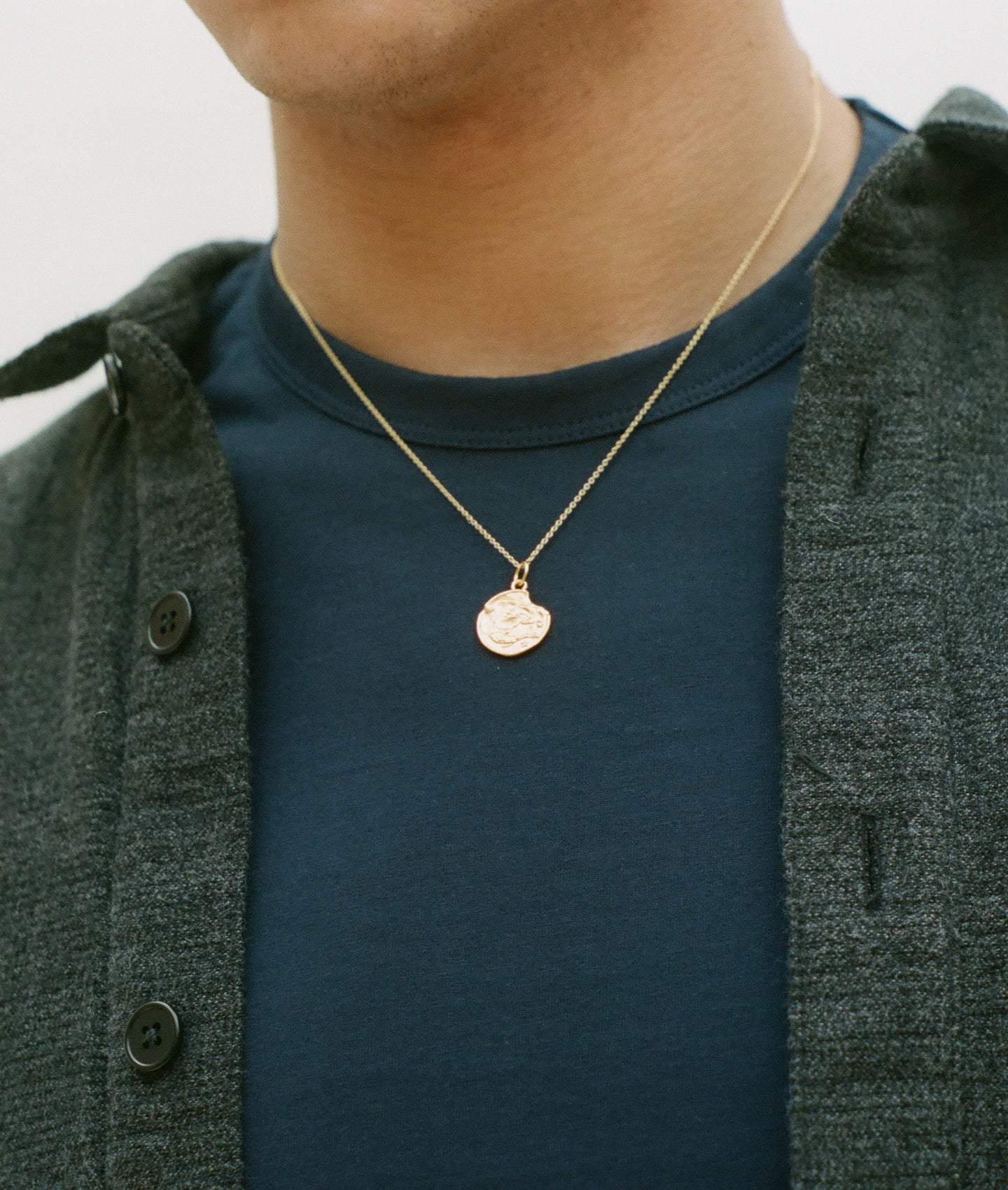 Model wearing Alighieri Gold Plated Pisces Zodiac Necklace  Medallion