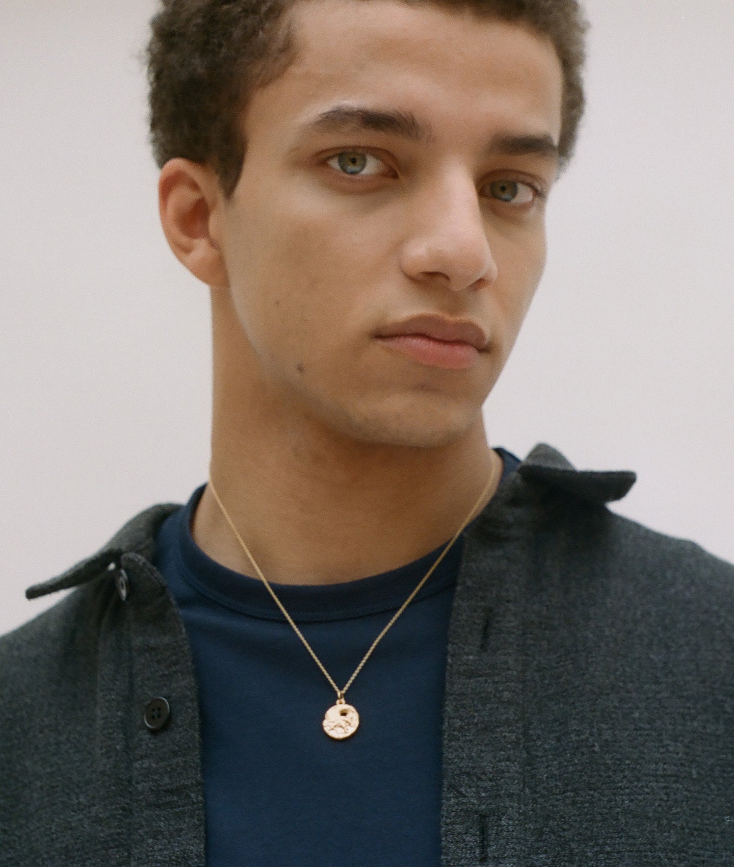 Model wearing  Alighieri Gold Plated Taurus Zodiac Necklace Medallion