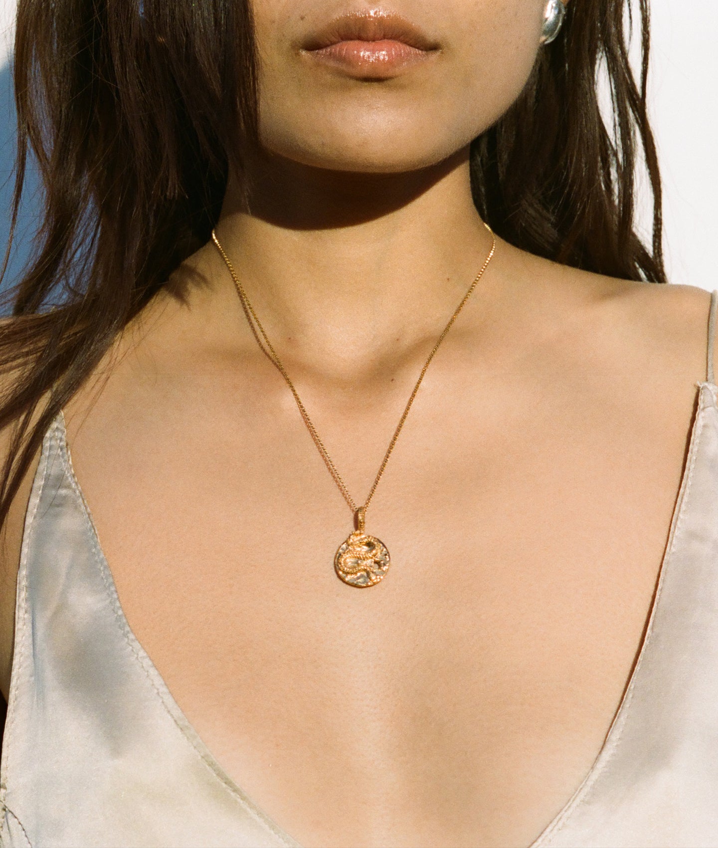 Model wearing Alighieri Medusa Necklace Coiled Snake Motif Gold Medallion