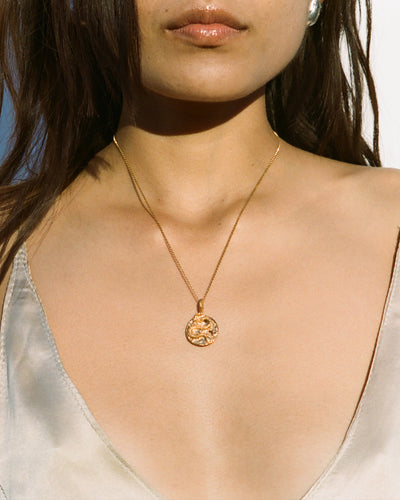 Model wearing Alighieri Medusa Necklace Coiled Snake Motif Gold Medallion