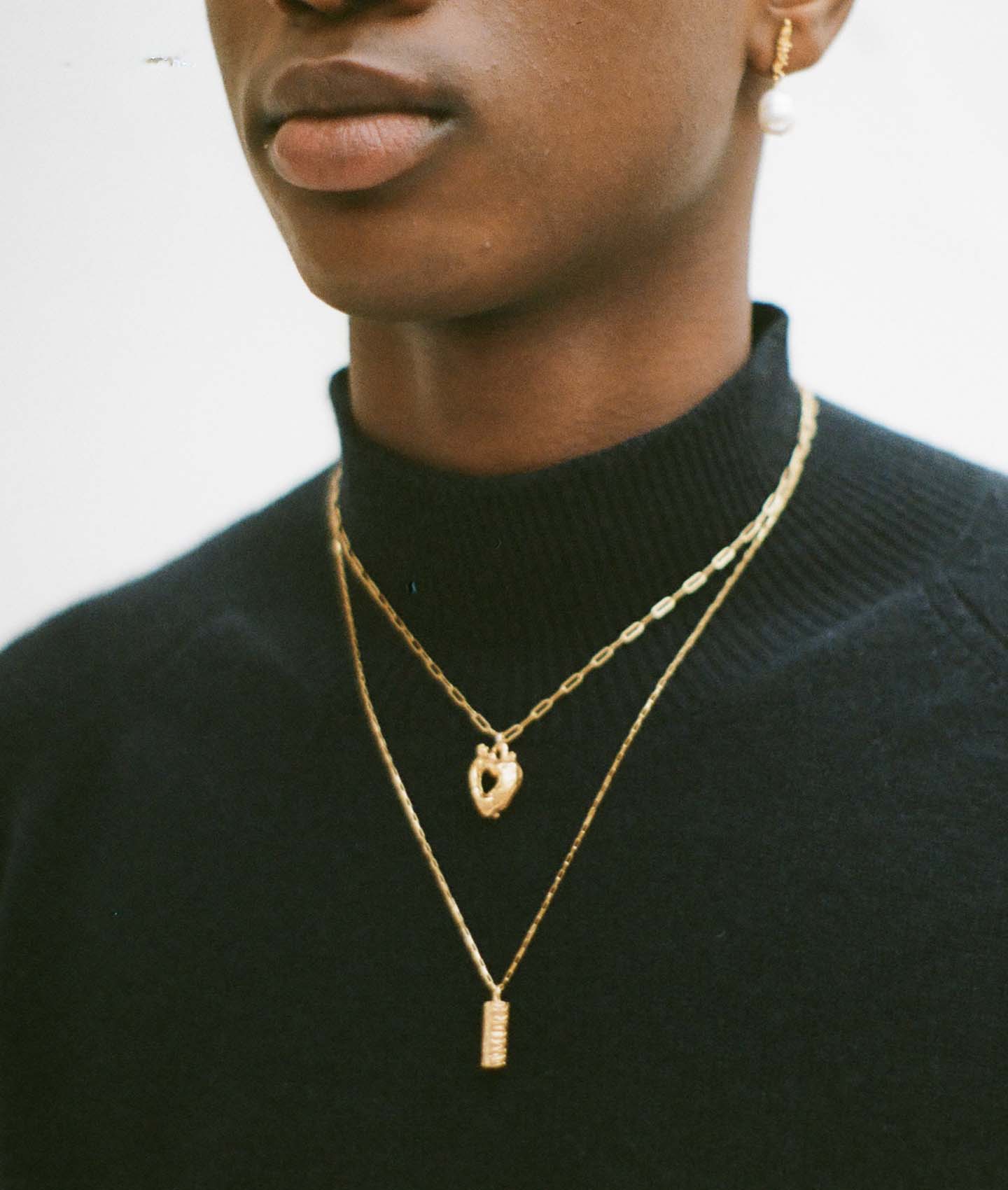 Model wearing Alighieri Box Chain Amore Pendant Necklace layering