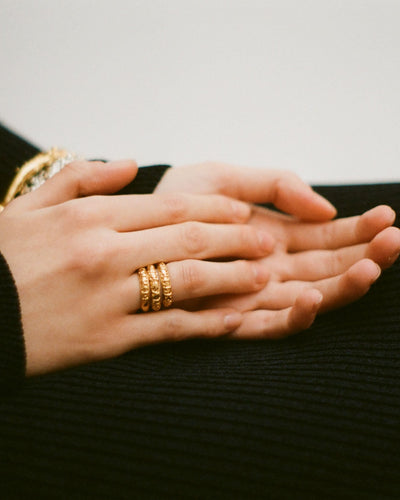 Model wearing Alighieri Gold Embossed Amore Ring Stacking