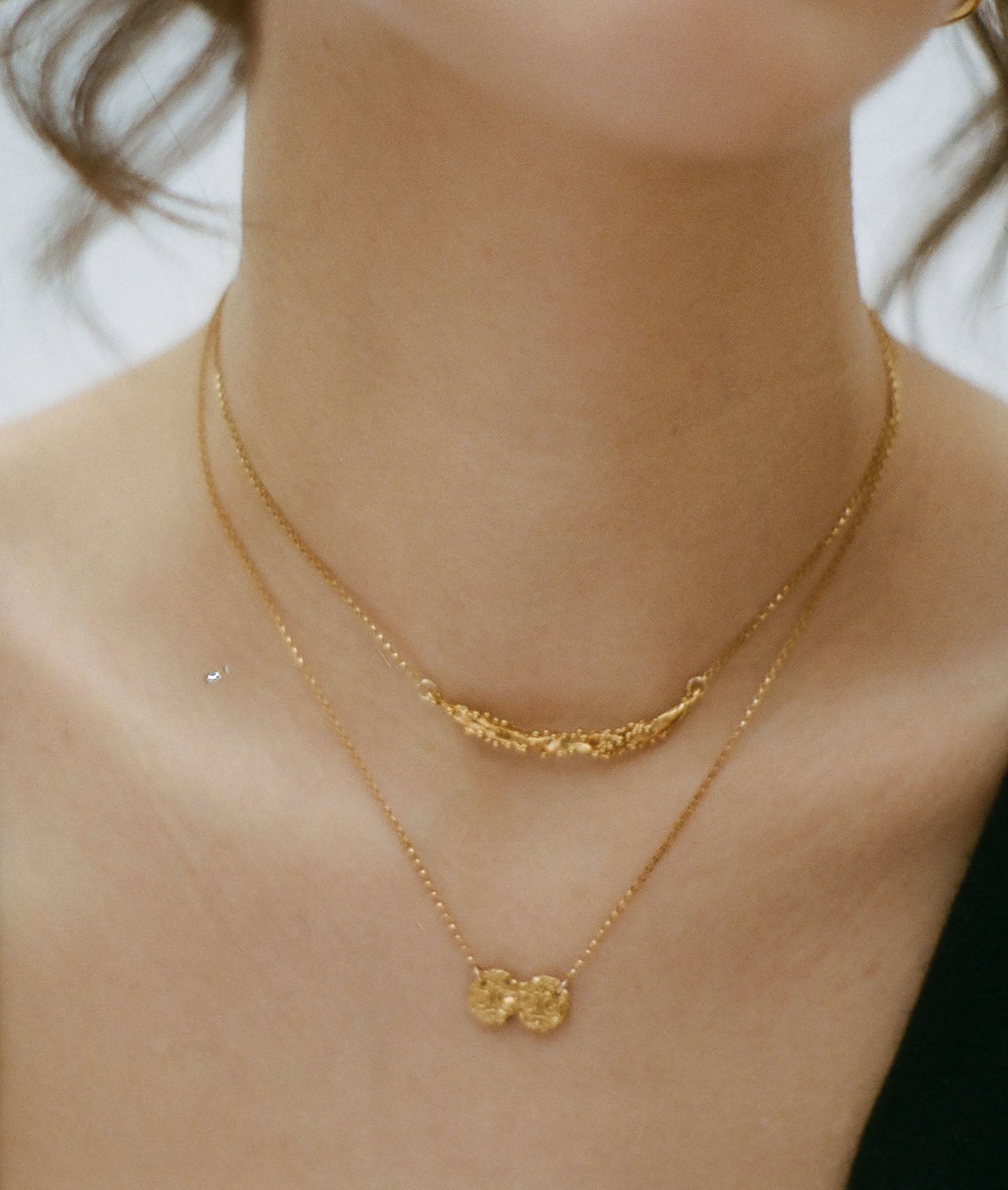model wearing Alighieri Bewitching Constellation Gold Bar Necklace layered
