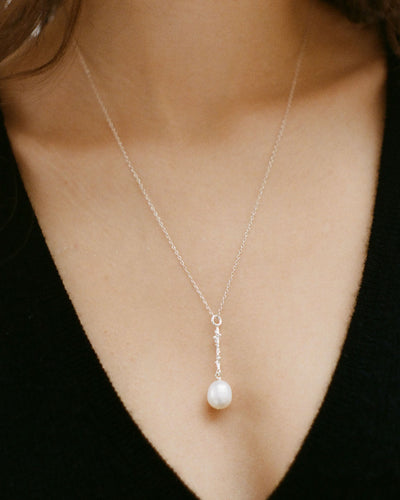 Model wearing Alighieri sterling silver pearl pendant necklace lustre of the moon